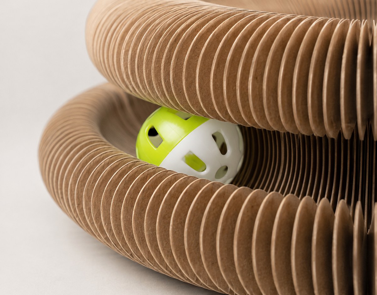 Close-up of the Loop's fine honeycomb pleats with the bell ball in its track and a paw reaching in